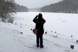 Berlin, Germany - December 31, 2025: A woman uses her smartphone to take a photo of the tailored