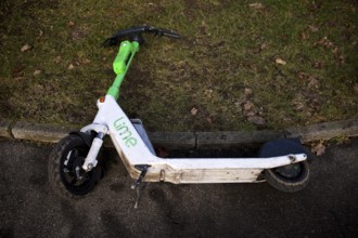 Carelessly left on the side of the road, e-scooter, scooter, in the bike rental company Lime,