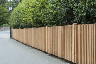 Wooden fence on the side of the road, vertical slats, town of Tegernsee, Upper Bavaria, Bavaria,