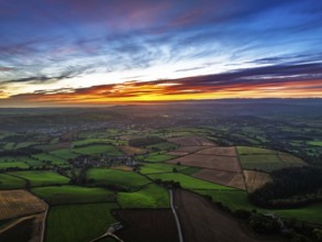 Sunset of Devon Farms and Fields over Berry Pomeroy from a drone, Totnes, England, United Kingdom
