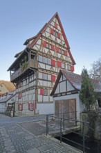 Historic half-timbered house Hoher Will built in 1697 with red shutters, multi-storey, Achgasse,