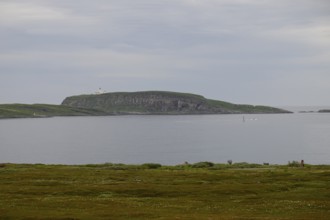 View of Reinoya and Hornoya islands from Vardö. The Vardö lighthouse can be seen on Hornoya. Vardø,