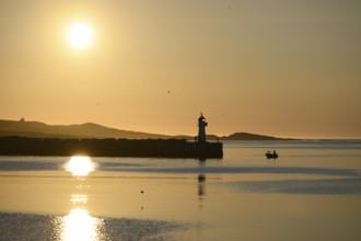 Harbour entrance with lighthouse and midnight sun, Vardø, Finnmark, Norway