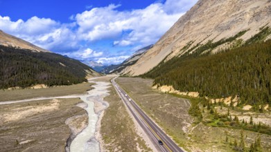Aerial view capturing the icefields parkway winding through the valley shaped by athabasca glacier