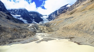 Sun shining over the athabasca glacier in jasper national park, alberta, canada, with meltwater