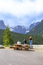 Tourists capturing breathtaking glacier views from a roadside stop along the scenic icefields
