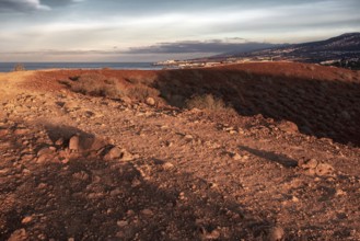Sunrise over a barren hilly landscape with wide shadows, Los Cristianos, Tenerife
