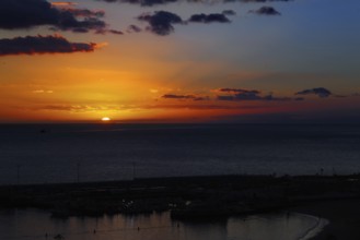 Dramatic sunset over the ocean with intense colors in the sky, Los Cristianos, Tenerife