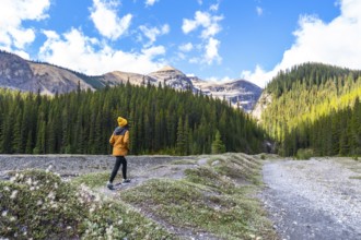 Female hiker walking along the ci fuentes path waterfall trail enjoying the scenic view of the