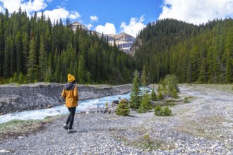Female hiker walking along the ci fuentes path, admiring the turquoise waters of the north