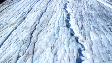 Melting glacial ice flowing down the athabasca glacier reveals stunning blue crevasses,