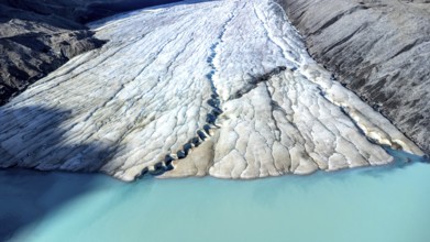 Athabasca glacier, part of the columbia icefield, is melting into a vibrant turquoise lake,