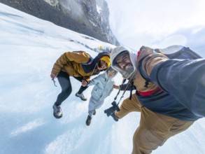 Happy family taking a selfie while standing on the athabasca glacier in jasper national park,