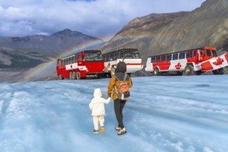 Tourists walking on the surface of athabasca glacier in jasper national park, alberta, canada, with