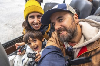 Happy family taking a selfie on a large ice explorer bus while visiting the athabasca glacier of