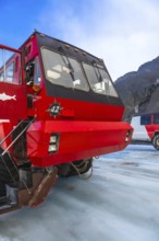 Red ice explorer bus parked on the athabasca glacier, offering breathtaking views of the canadian