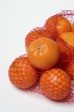 Clementines in a net, tropical fruit