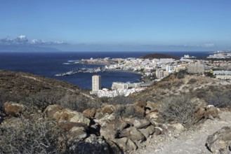 Hill view of the tourist town of Los Cristianos and the blue sea on a sunny day, Los Cristianos