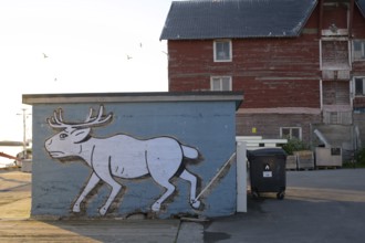 Mural depicting a reindeer at the harbor. Vardö street art phenomenon created by the festival
