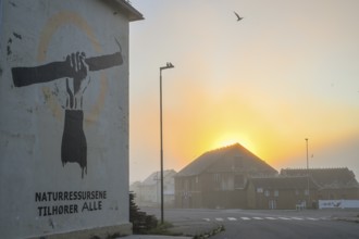 Wall painting with stretched arm and gaff. The inscription says Natural resources belong to