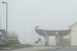 Fishermen carrying a rowboat in fog sculpture, Vardø, Finnmark, Norway