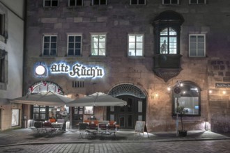 Historic restaurant, Alte Küch'n, with choirs in the evening lighting in the old town,