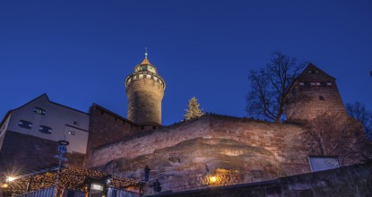 Illuminated Sinwell Tower, built in the 13th century, in the evening sky, Kaiserburg, Nuremberg,