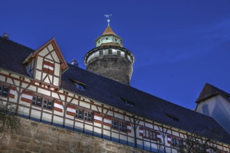 Sinwell Tower built in the 13th century, on the Nuremberg Kaiserburg in the evening lighting, blue