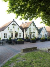 Row of houses, village square, town center, Greetsiel, Municipality Krummhörn, East Frisia, Germany