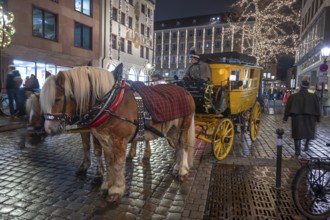 Horse-drawn carriage ride in a historic stagecoach at Chriskindlesmarkt, Hauptmarkt, Nuremberg,
