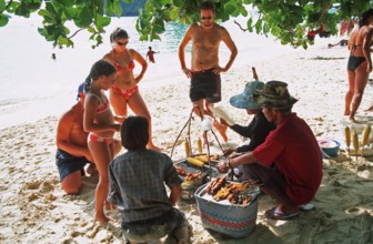 Woman with food store and customers on Pranang Cave beach, two years in front of the tsunami,