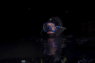 Divers at night in Lake Walen. Tauchplatz Känzeli, Mols, Canton of St. Gallen, Switzerland