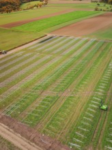 Aerial view of fields with solar frame on green fields, energy transition, construction of PV open