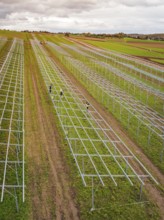 Structures of an incipient solar plant in fields in a rural area, energy transition, construction