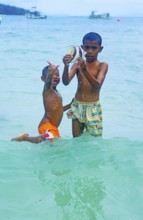 Two boys with a tropical fish on Ko Phi Phi Don, two years in front of the tsunami, Thailand,