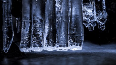 Close-up of blue icicles. Cool, frosty atmosphere reflecting the winter cold, Zwickenbach,