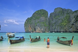 People, longtail boats on Maya Bay beach, known from the movie The Beach, one year in front of the