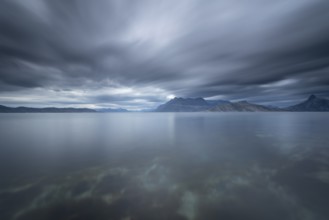 The Vestfjord in Nordland, Norway, near Bodø, impresses with a dramatic atmosphere. Dark clouds