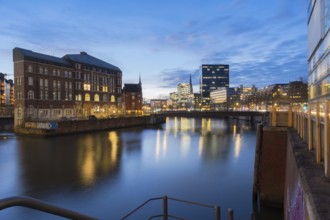 View from Oberbaum Bridge of the Zollkanal and Teerhof at blue hour with reflections in the water