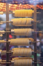 The trendy Chimney Cake stand at Stuttgart Christmas Market offers freshly baked, sweet treats. The
