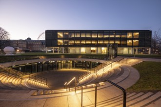 The state parliament of Stuttgart glows impressively in the evening. The architecture is