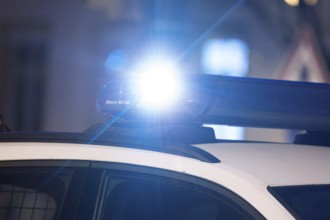 Symbolic image police operation: close-up of a blue light on a police car (digitally reworked)