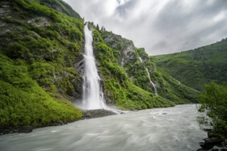 Horsetail Falls waterfall on the Lowe River in a green gorge, long exposure, Keystone Canyon,