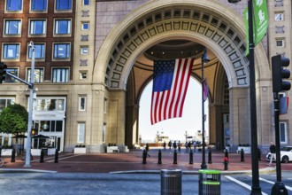 American flag fluttering, distinctive archway, Boston Harbor Hotel, Rowes Wharf, Freedom Trail,
