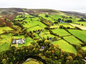 Autumn colours of Farms over River Wye and Road A470 from a drone, Llanidloes, Powys,