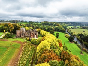 Autumn Colours over ruins of Goodrich Castle and River Wye from a drone, Goodrich, Herefordshire,