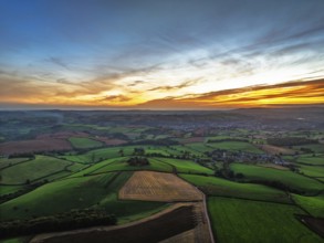 Sunset of Devon Farms and Fields over Berry Pomeroy from a drone, Totnes, England, United Kingdom