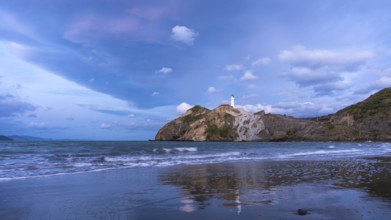 Castlepoint Beach, ocean and lighthouse on a rock, in the evening, after sunset. Castlepoint,
