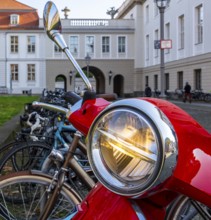 Detailed photo, headlights on a red Vespa, Berlin, Germany