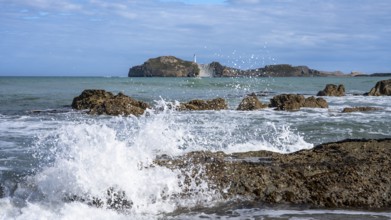 Castlepoint Beach and Castlepoint Lighthouse, ocean, waves, surf, sandy beach, rocks. Castlepoint,